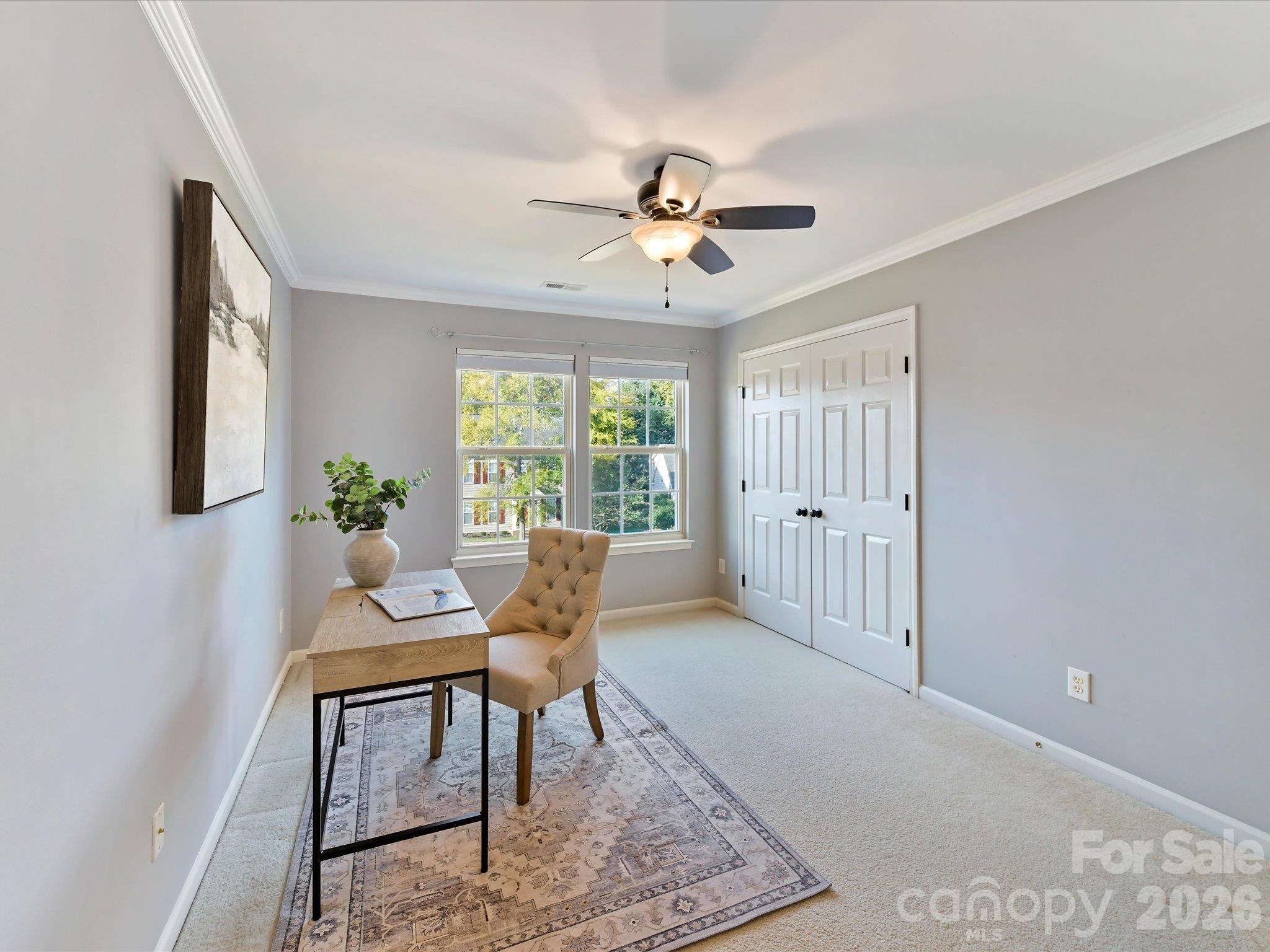 Versatile second bedroom or flex space featuring neutral finishes, soft carpeting, abundant natural light, and ample room for a home office or guest retreat. - 3819 Waters Reach Lane, Indian Trail