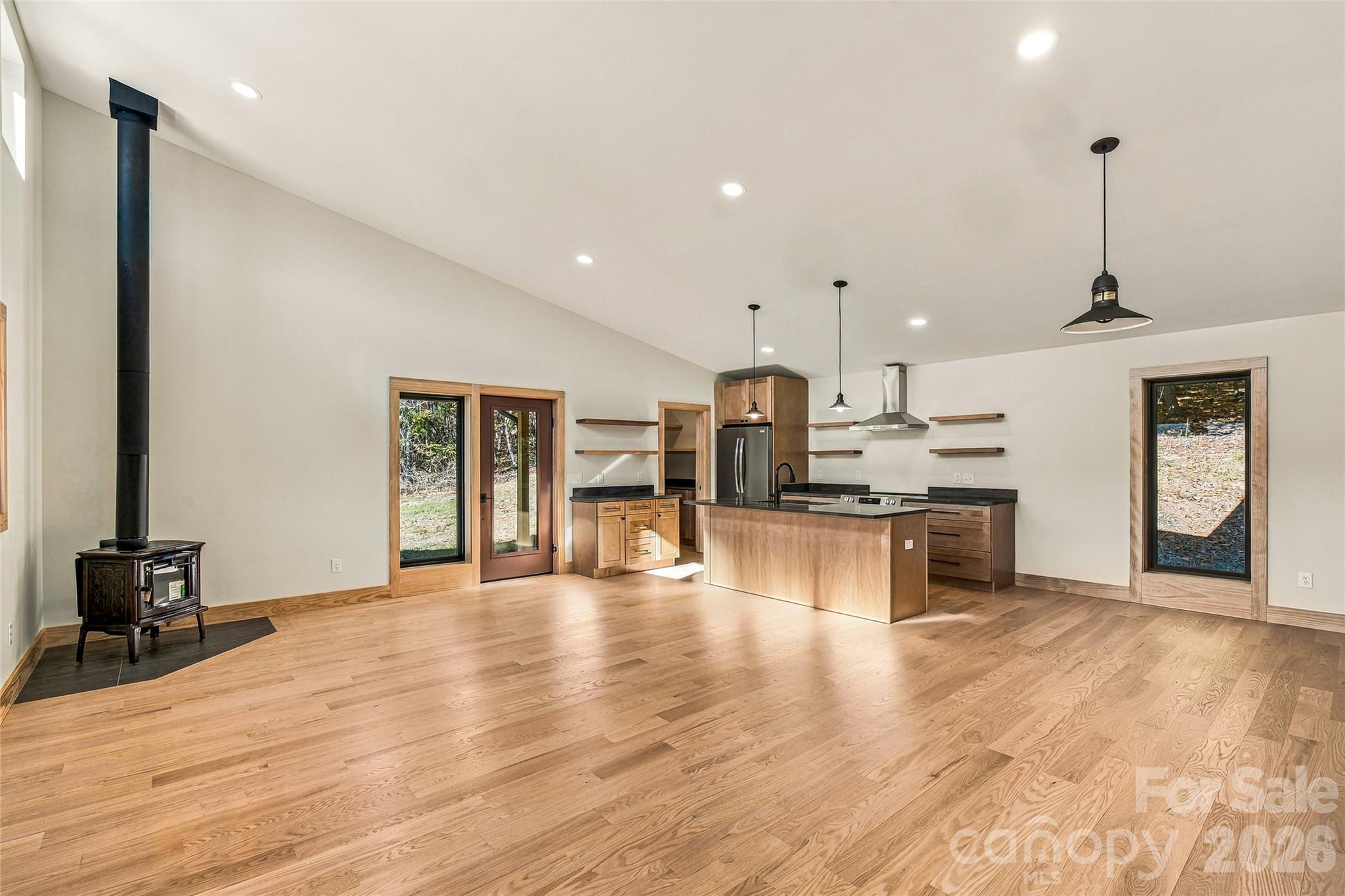 Light-filled, open-concept living with soaring vaulted ceilings. - 205 Blue Moon Lane, Candler