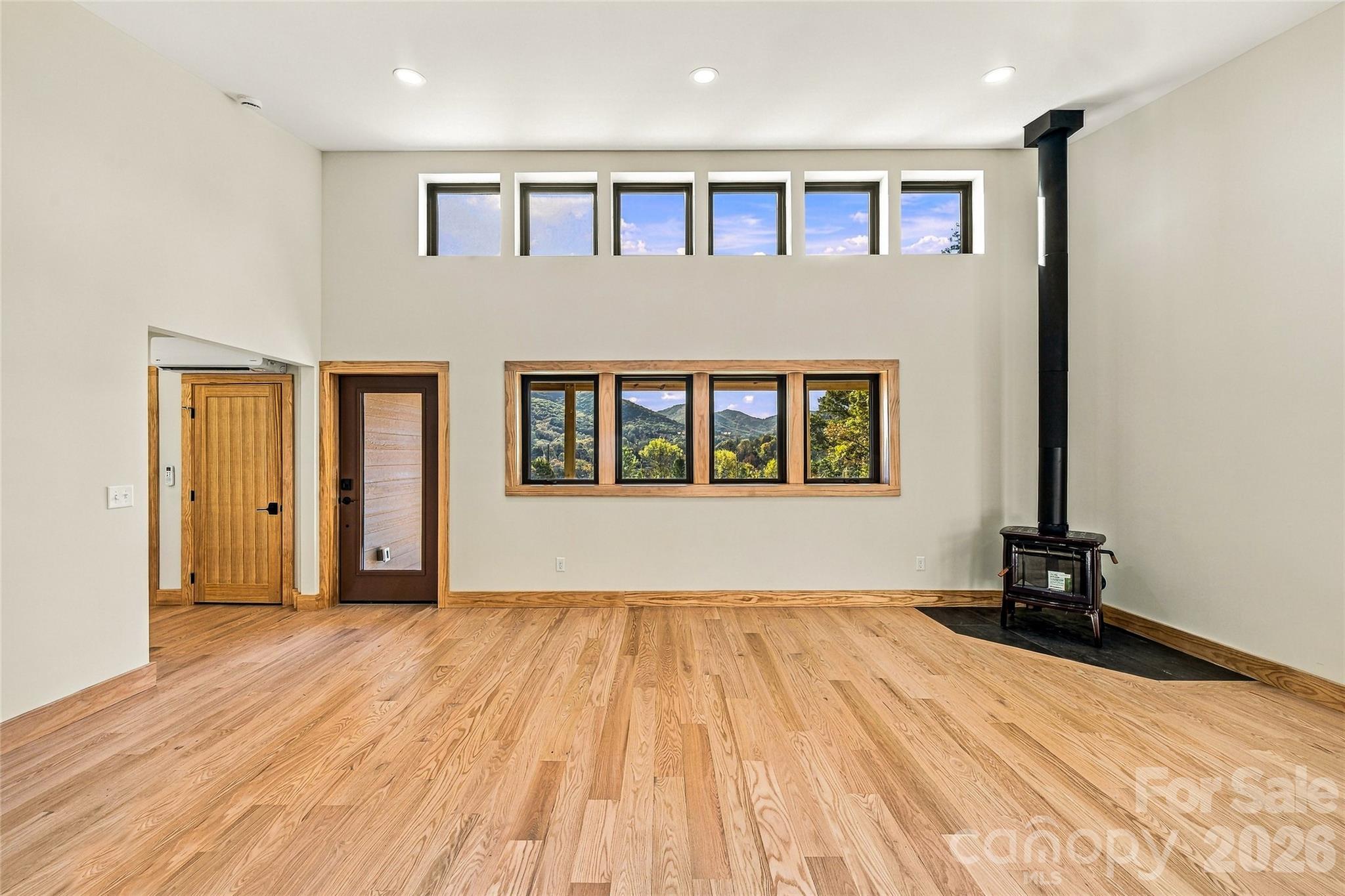 Clerestory windows, vaulted ceilings, and a premium HearthStone wood stove. - 205 Blue Moon Lane, Candler