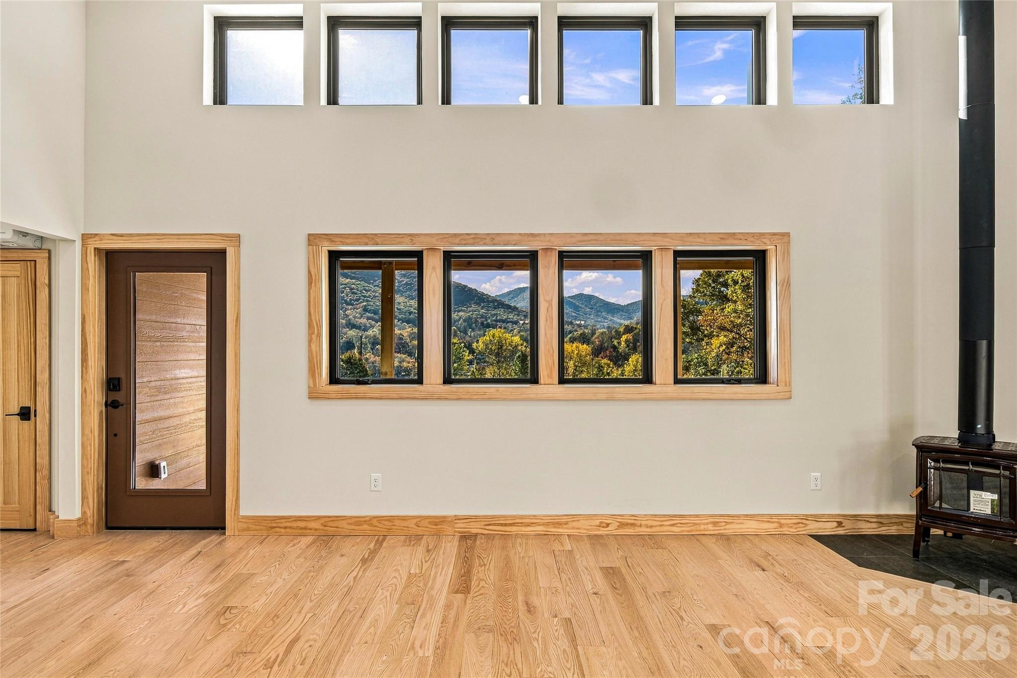 Expansive windows showcase the surrounding mountain scenery. - 205 Blue Moon Lane, Candler
