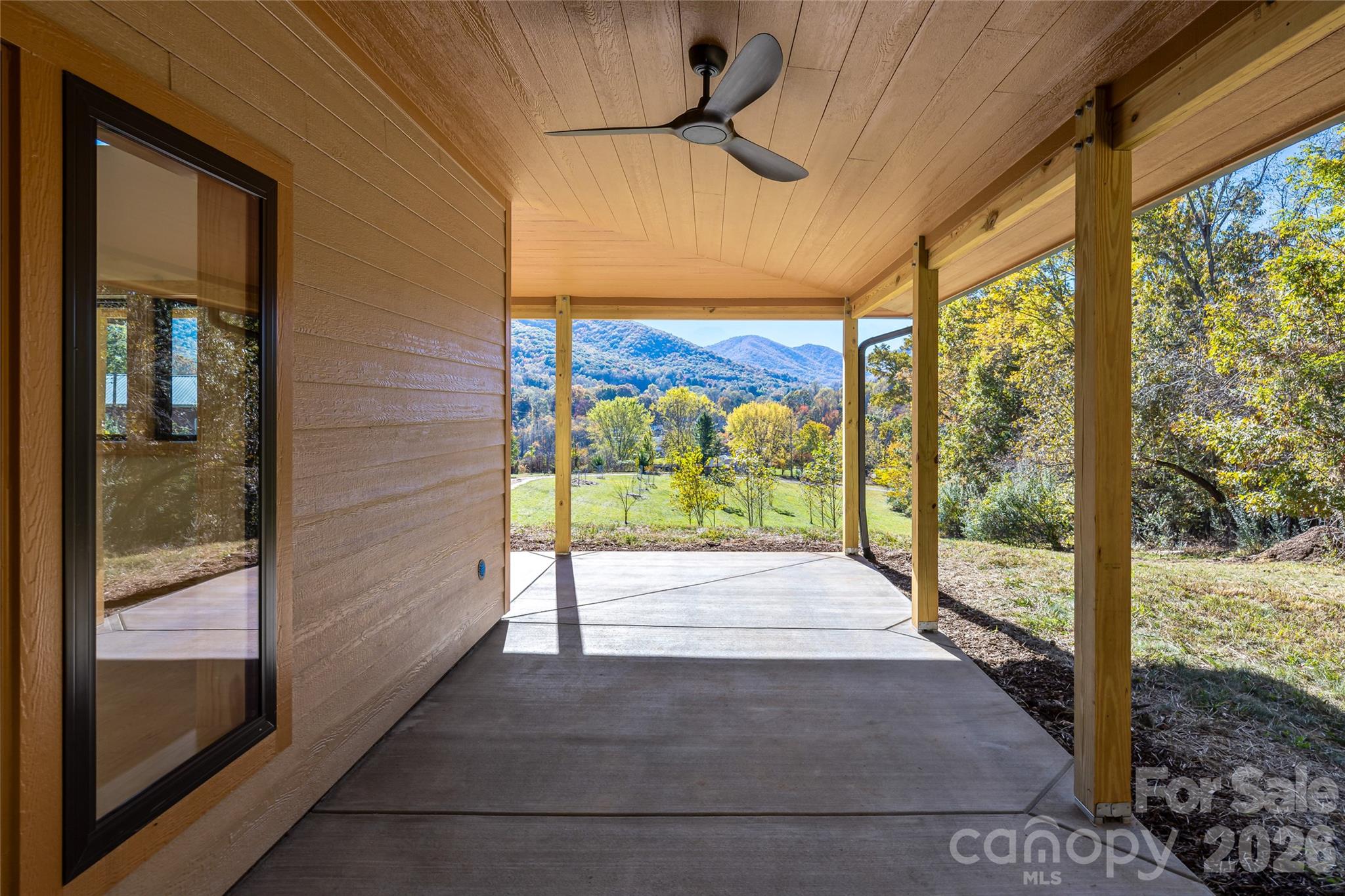 Spacious covered porch for year-round outdoor enjoyment. - 205 Blue Moon Lane, Candler
