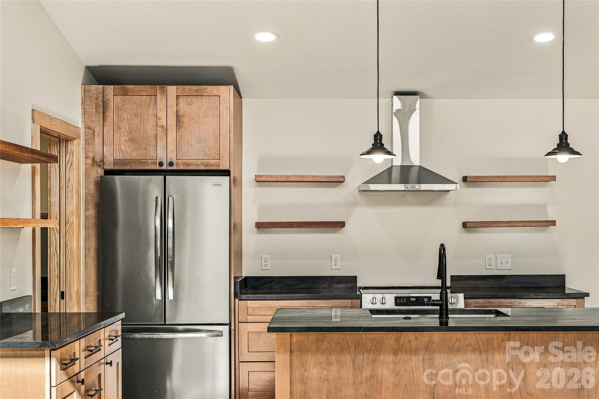 Quality cabinetry, stainless appliances, and beautiful natural finishes. - 205 Blue Moon Lane, Candler