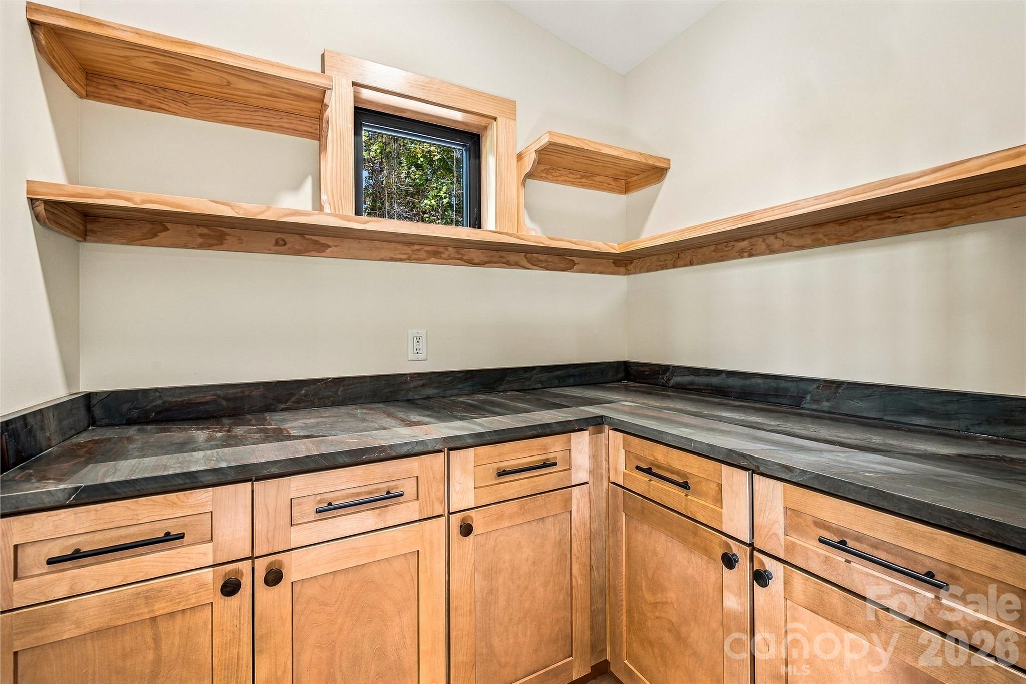 Warm wood cabinetry, quality countertops, and thoughtful details. - 205 Blue Moon Lane, Candler