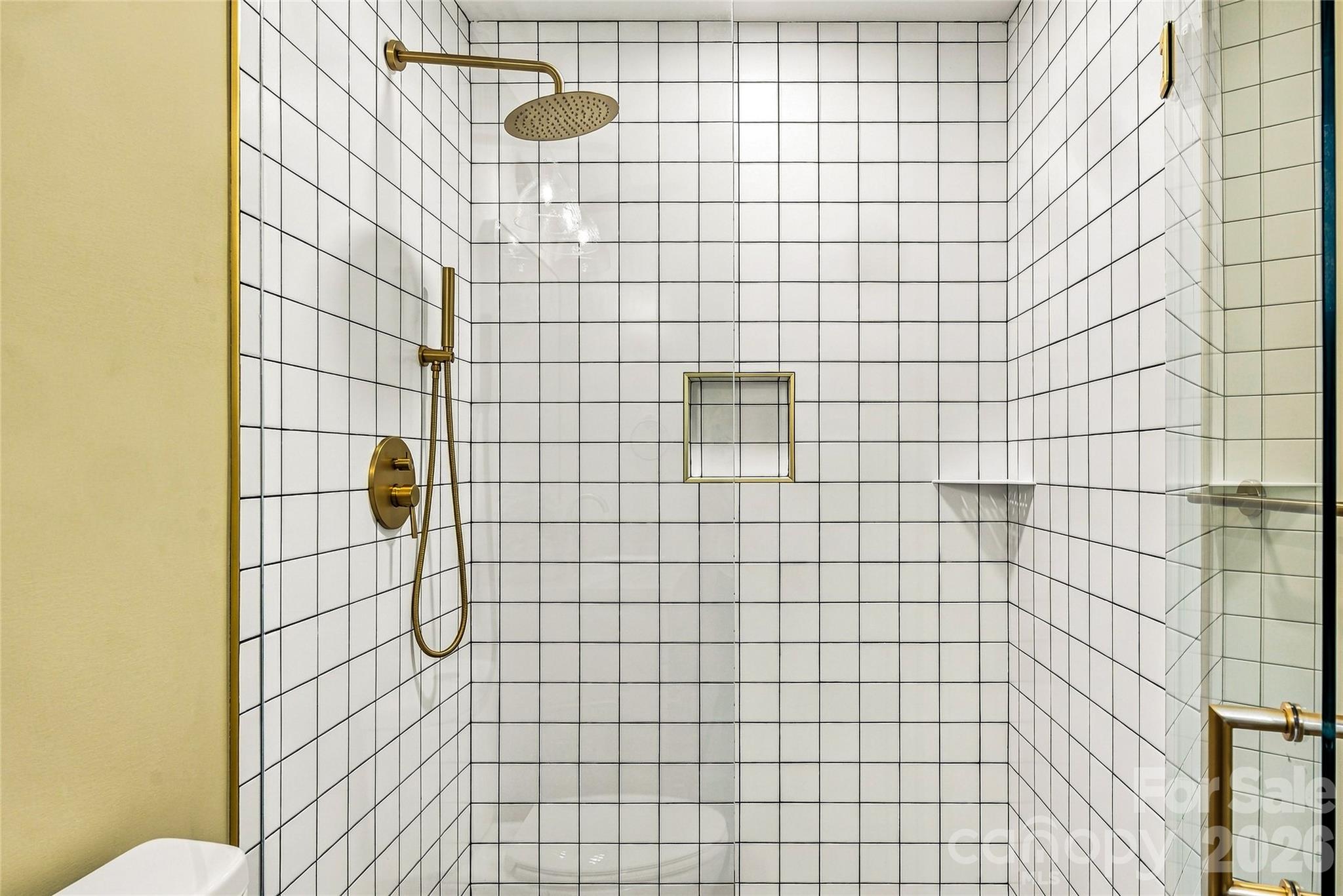 Custom tiled shower with attractive fixtures and built-in niches. - 205 Blue Moon Lane, Candler