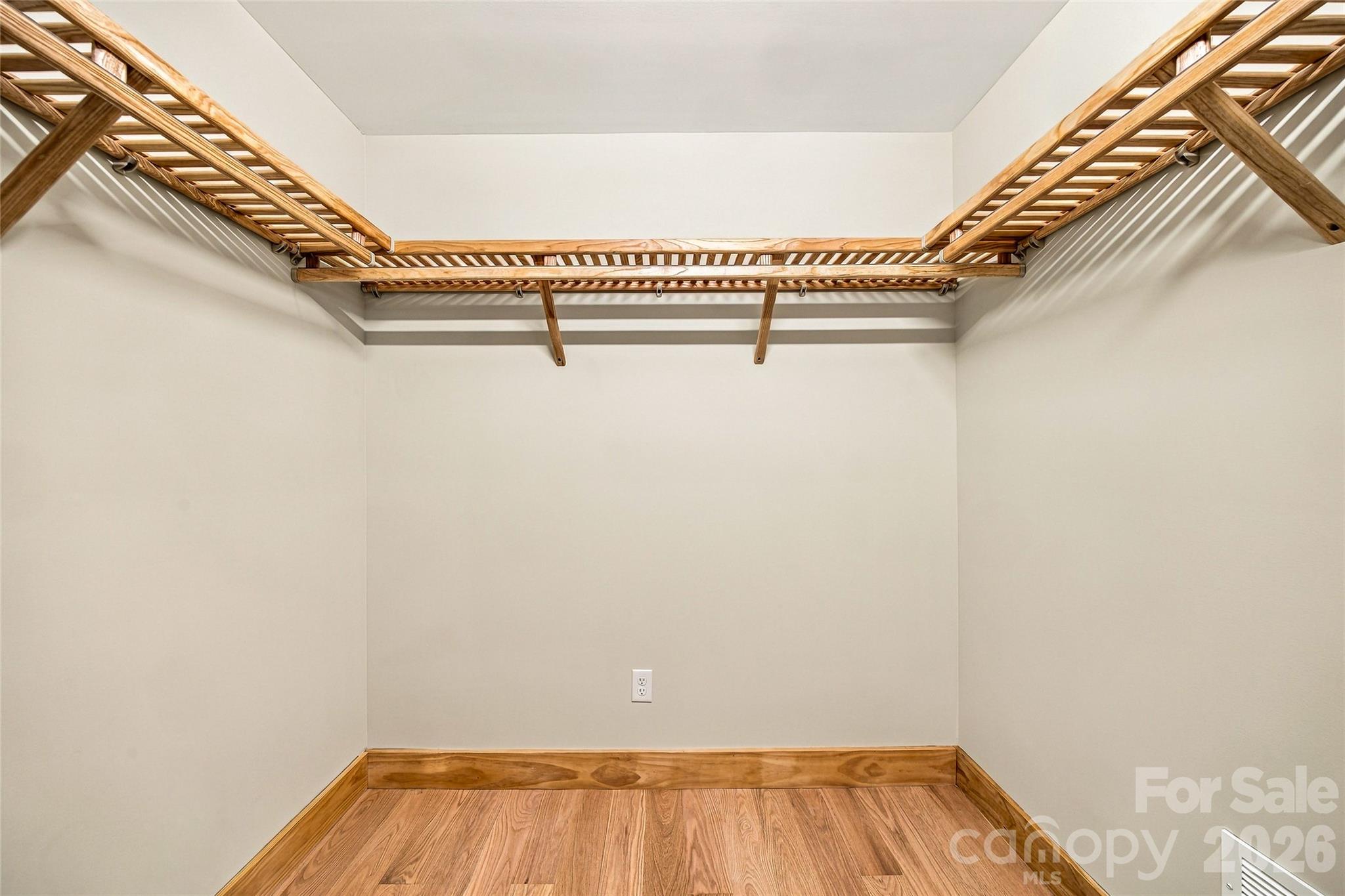 Generous walk-in closet with custom wood shelving. - 205 Blue Moon Lane, Candler
