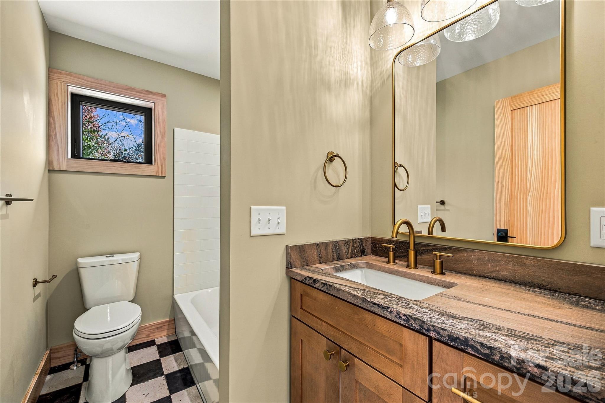 Attractive bathroom with wood vanity and classic tile flooring. - 205 Blue Moon Lane, Candler