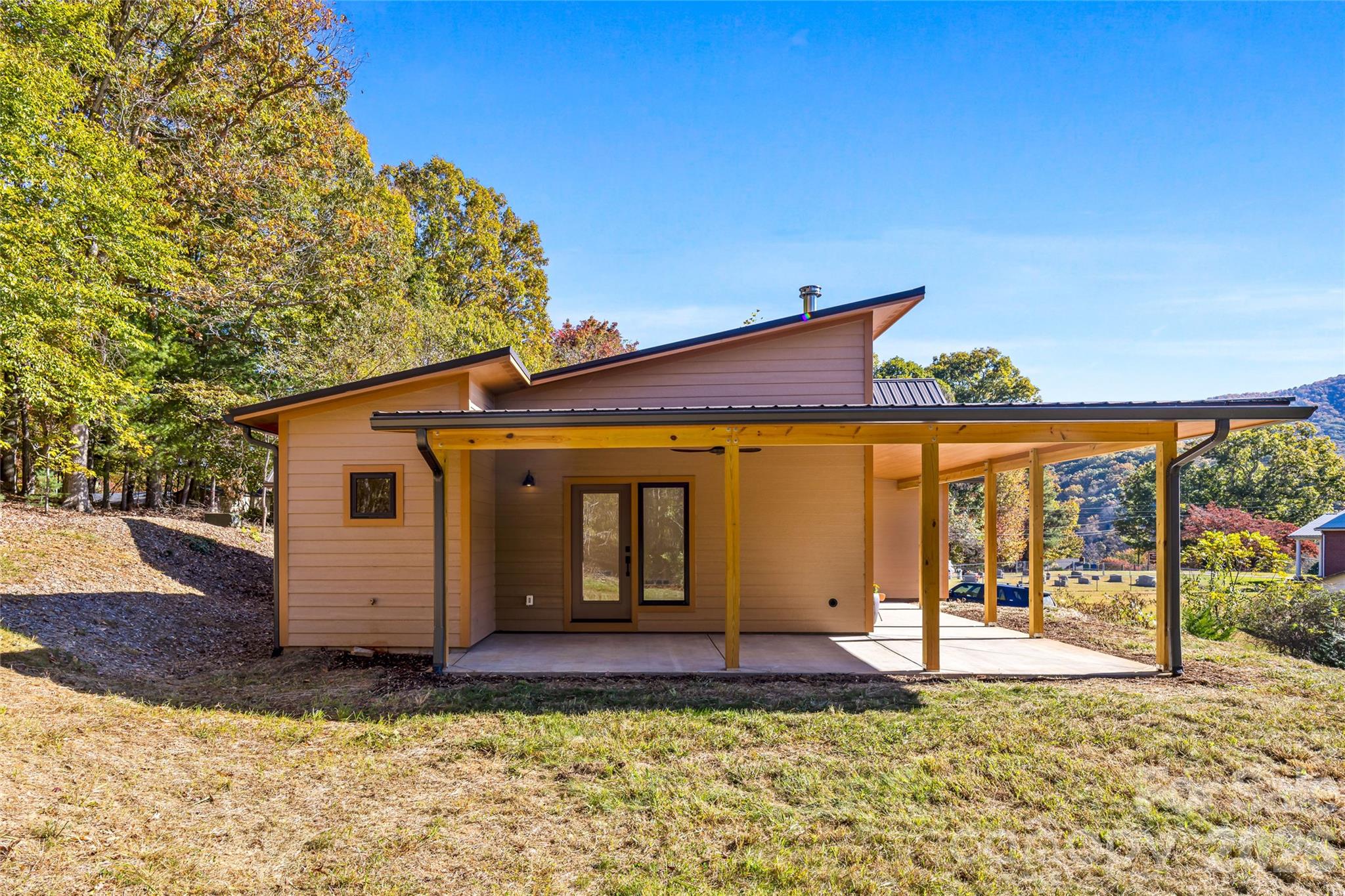 Expansive covered porch extends your outdoor living space. - 205 Blue Moon Lane, Candler