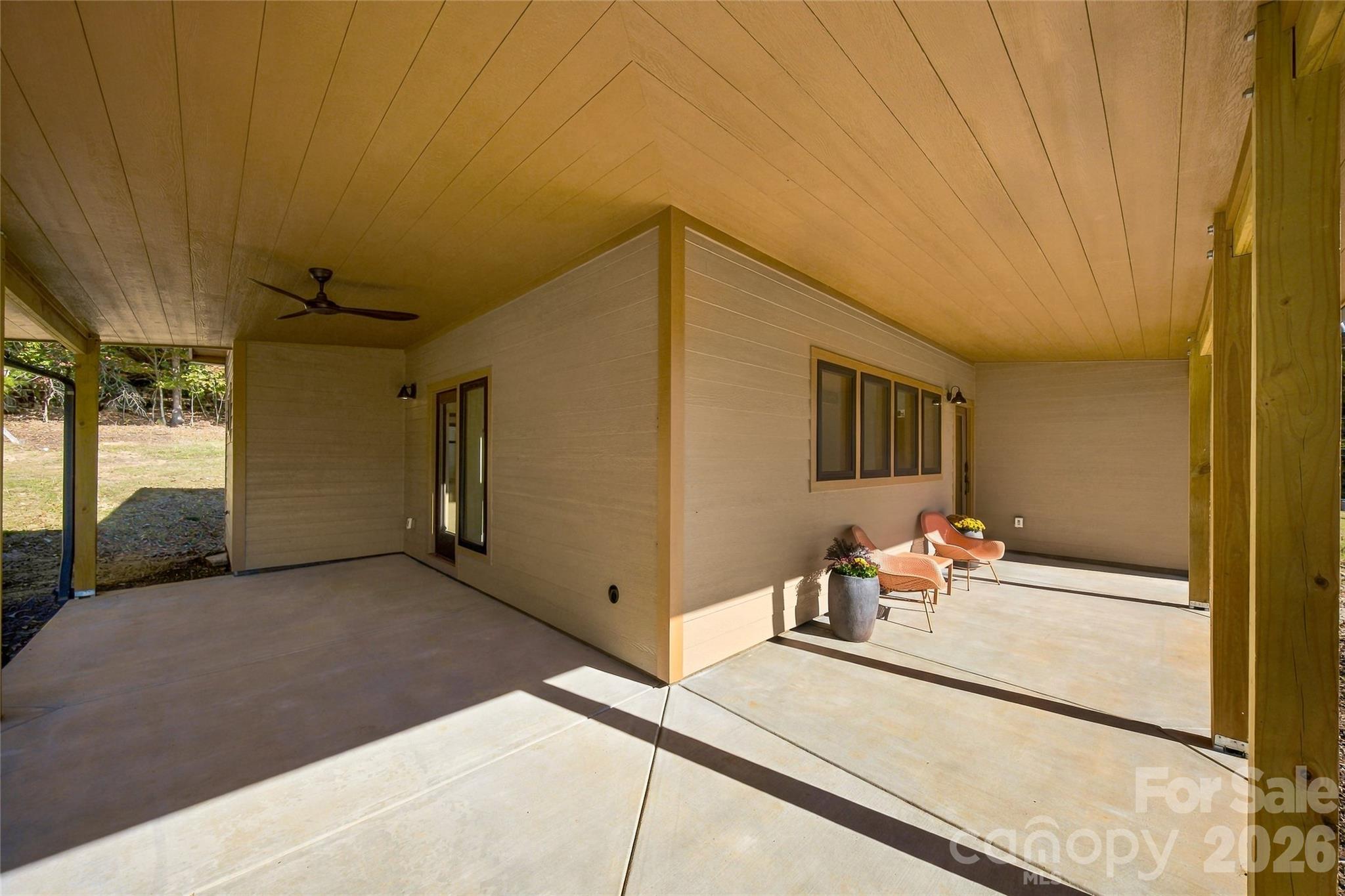Wraparound covered porch offers shade and space to entertain. - 205 Blue Moon Lane, Candler