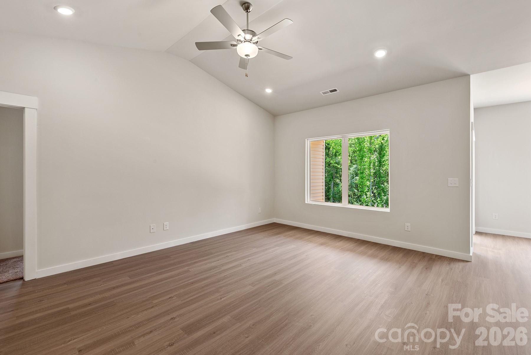 Natural light pours into this inviting living room with vaulted ceilings. - 1426 Tristen Road, Richburg