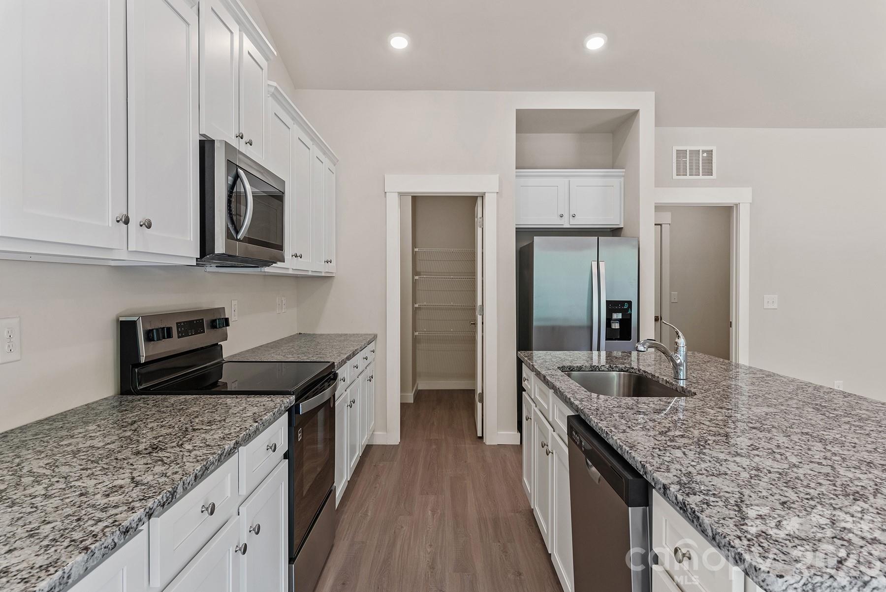 Stainless steel appliances offer a modern and polished look. - 1426 Tristen Road, Richburg