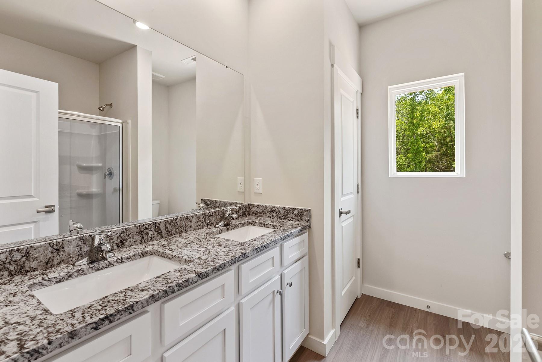 Primary en-suite showcases a stylish dual-sink vanity and functional layout. - 1426 Tristen Road, Richburg