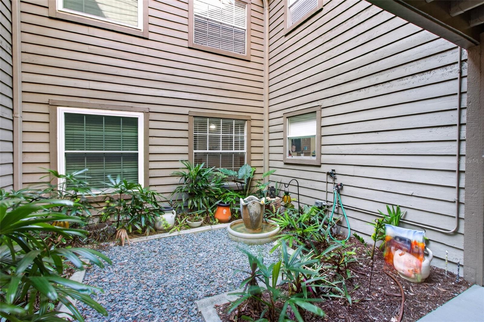 Courtyard just before front door. Kitchen window & bedroom 2 face this. - 2500 WINDING CREEK BLVD #I106, CLEARWATER