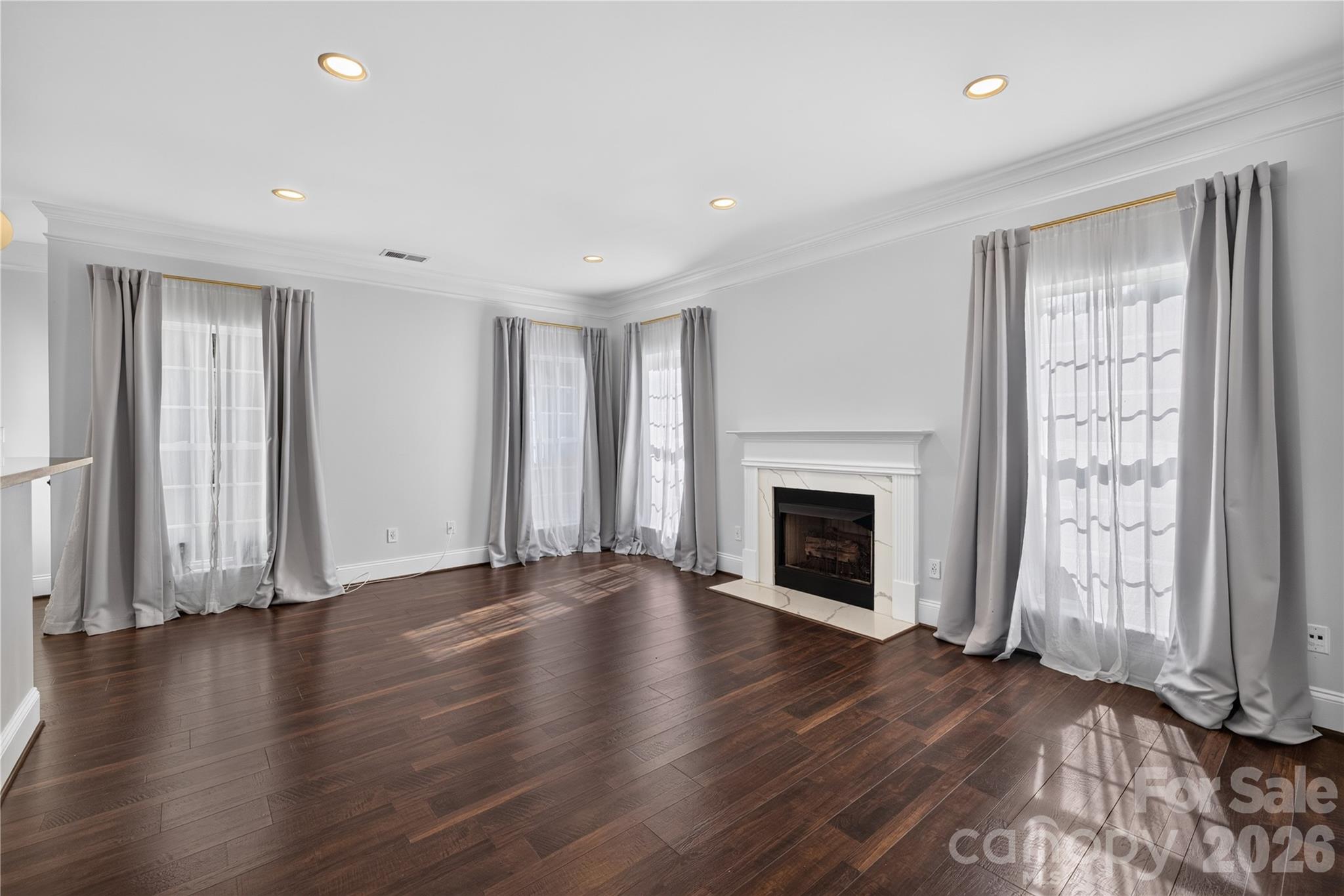 Living Room filled with natural light and centered around a cozy gas fireplace - 12520 Vantage Point Lane, Huntersville