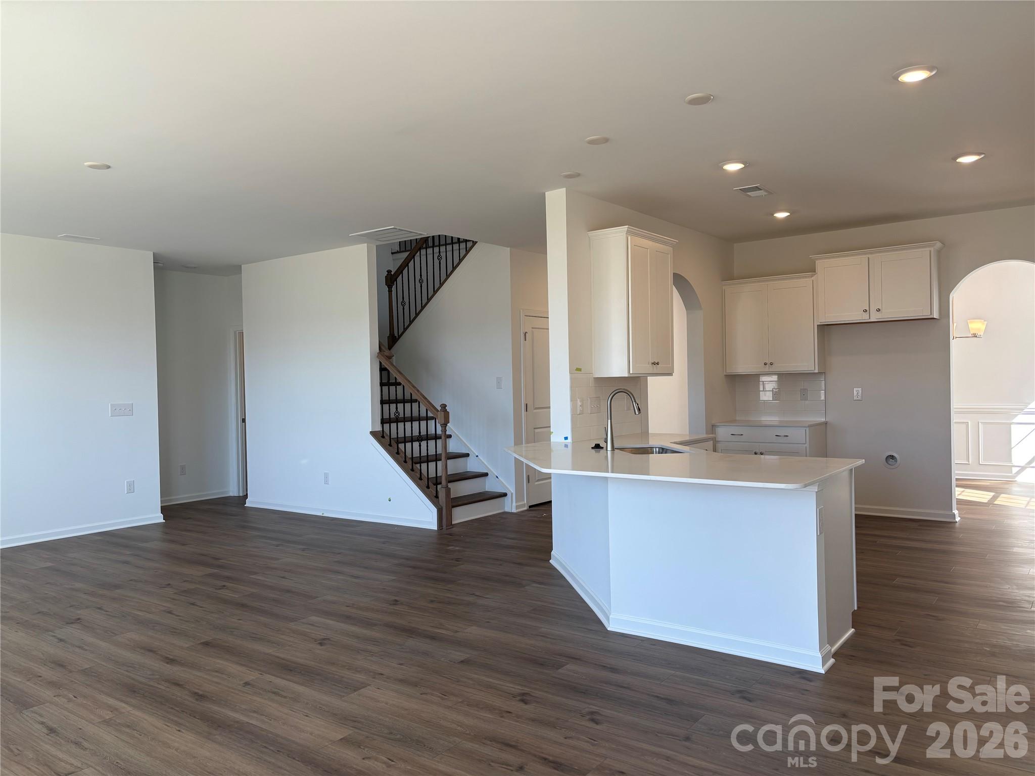 Looking from the breakfast area out to the living room, through the hall is the bedroom with its own full bath on the main - 1735 Grassy Knoll Trail, Maiden