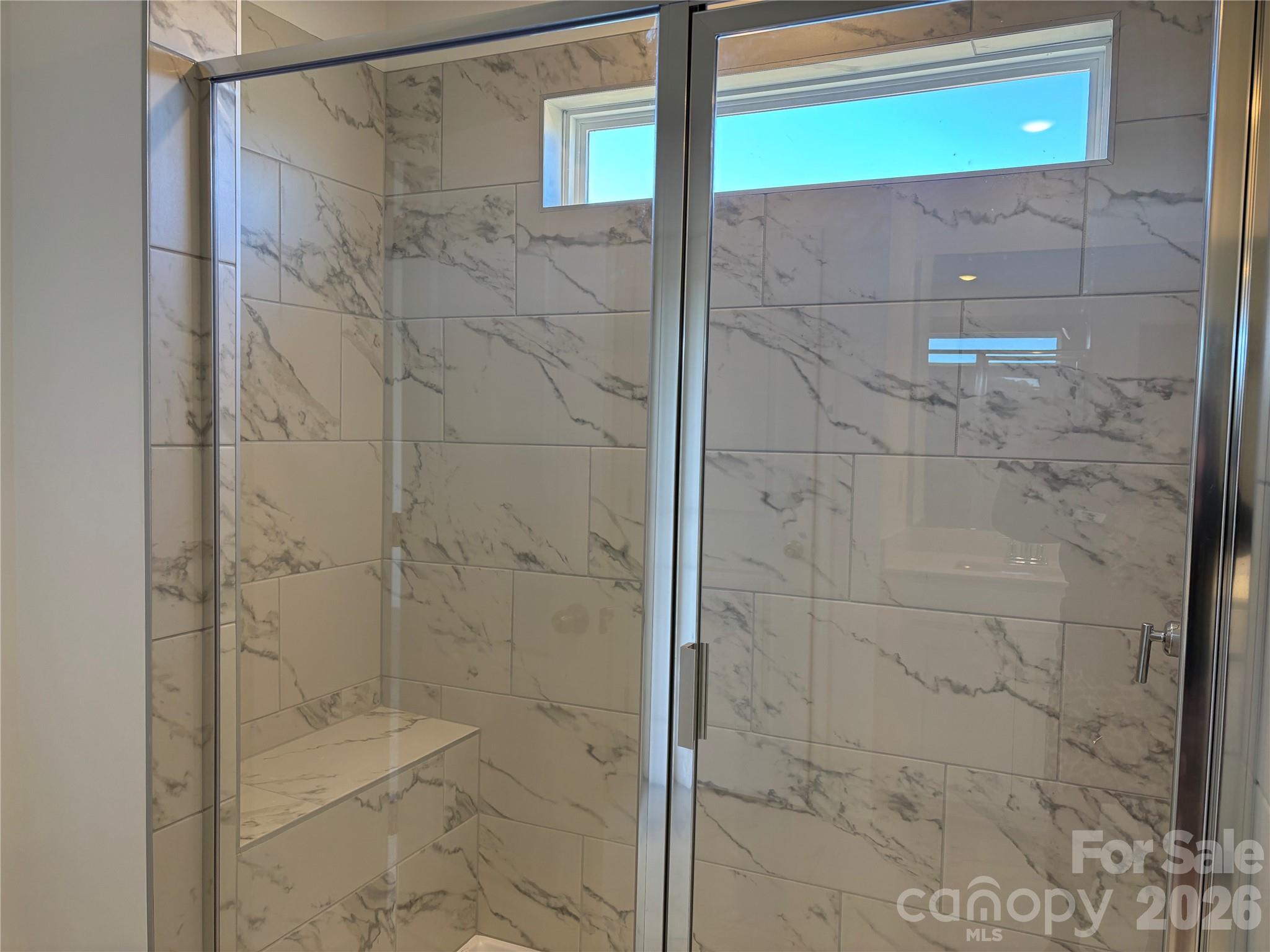 Lots of natural light in your primary bathroom with this transom window - 1735 Grassy Knoll Trail, Maiden