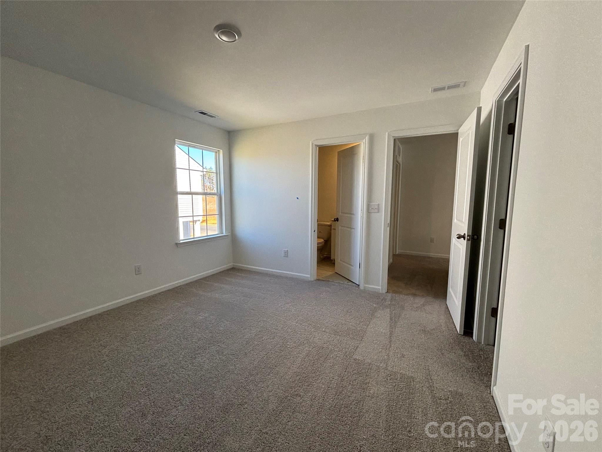 Looking from the last bedroom on the upper floor towards the attached bathroom and door to the hall - 1735 Grassy Knoll Trail, Maiden