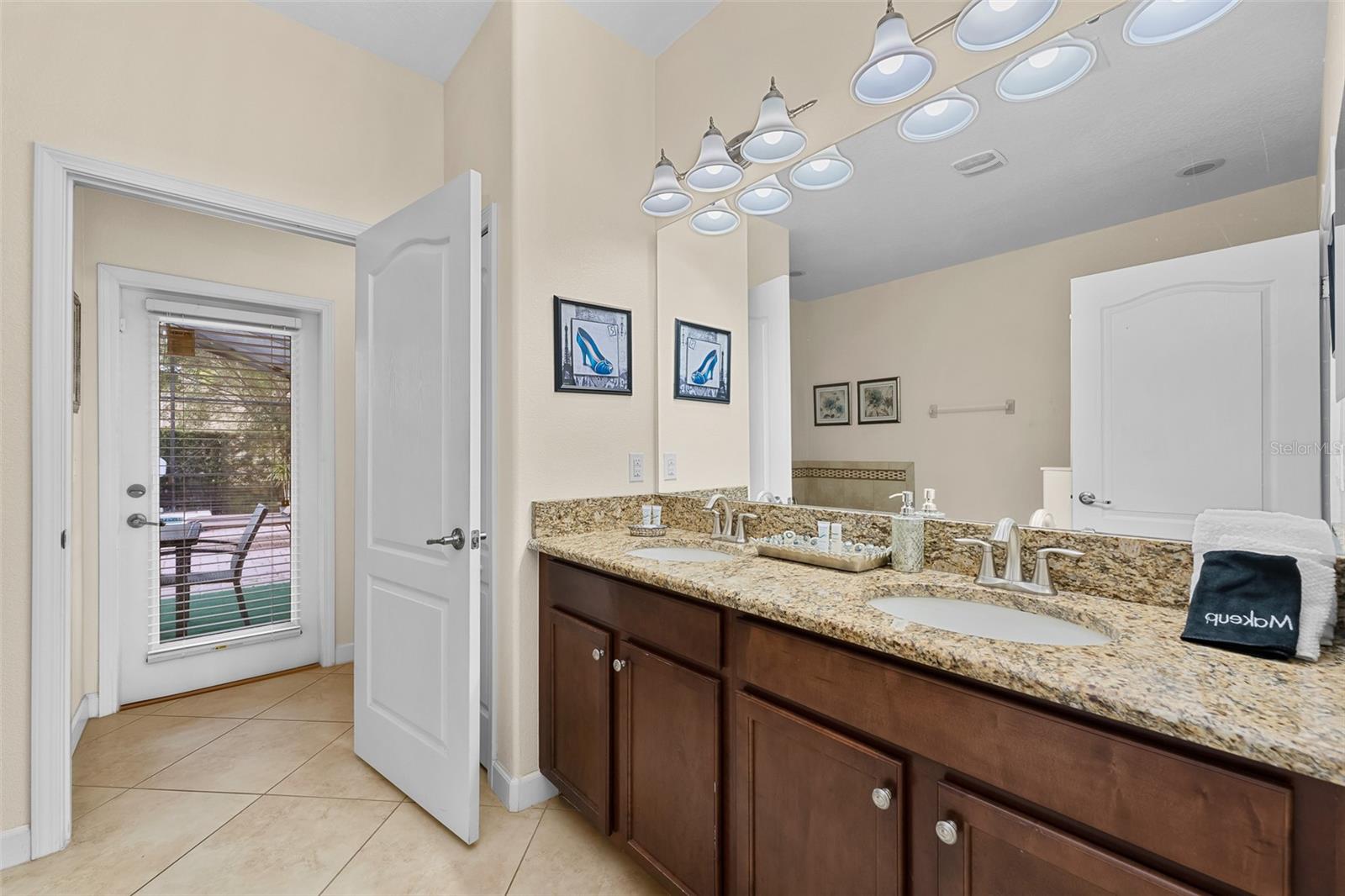 Spacious Primary Bathroom with Granite Double Vanity and Generous Counter Space - 1520 MOON VALLEY DR, DAVENPORT