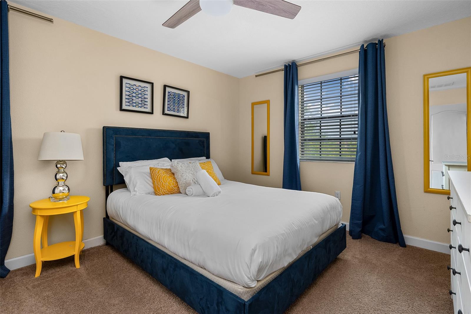 Comfortable Queen Bedroom with Navy and Yellow Accents and Ceiling Fan - 1520 MOON VALLEY DR, DAVENPORT