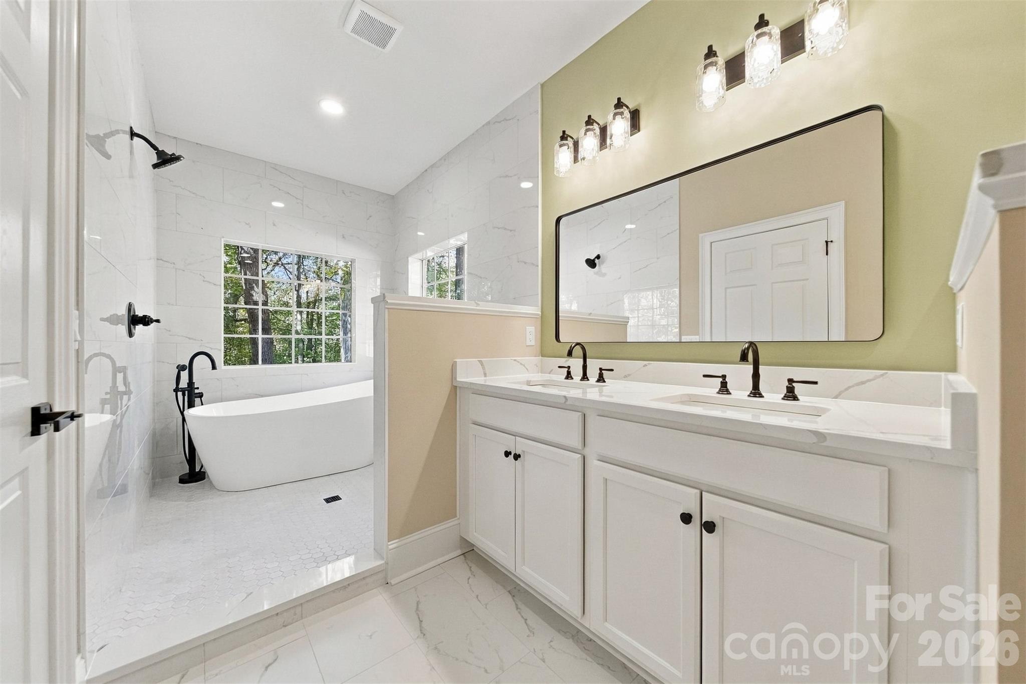 Updated primary bath complete with a walk-in stand up shower big enough for two and soaking tub. - 3442 Sourwood Court, Lincolnton