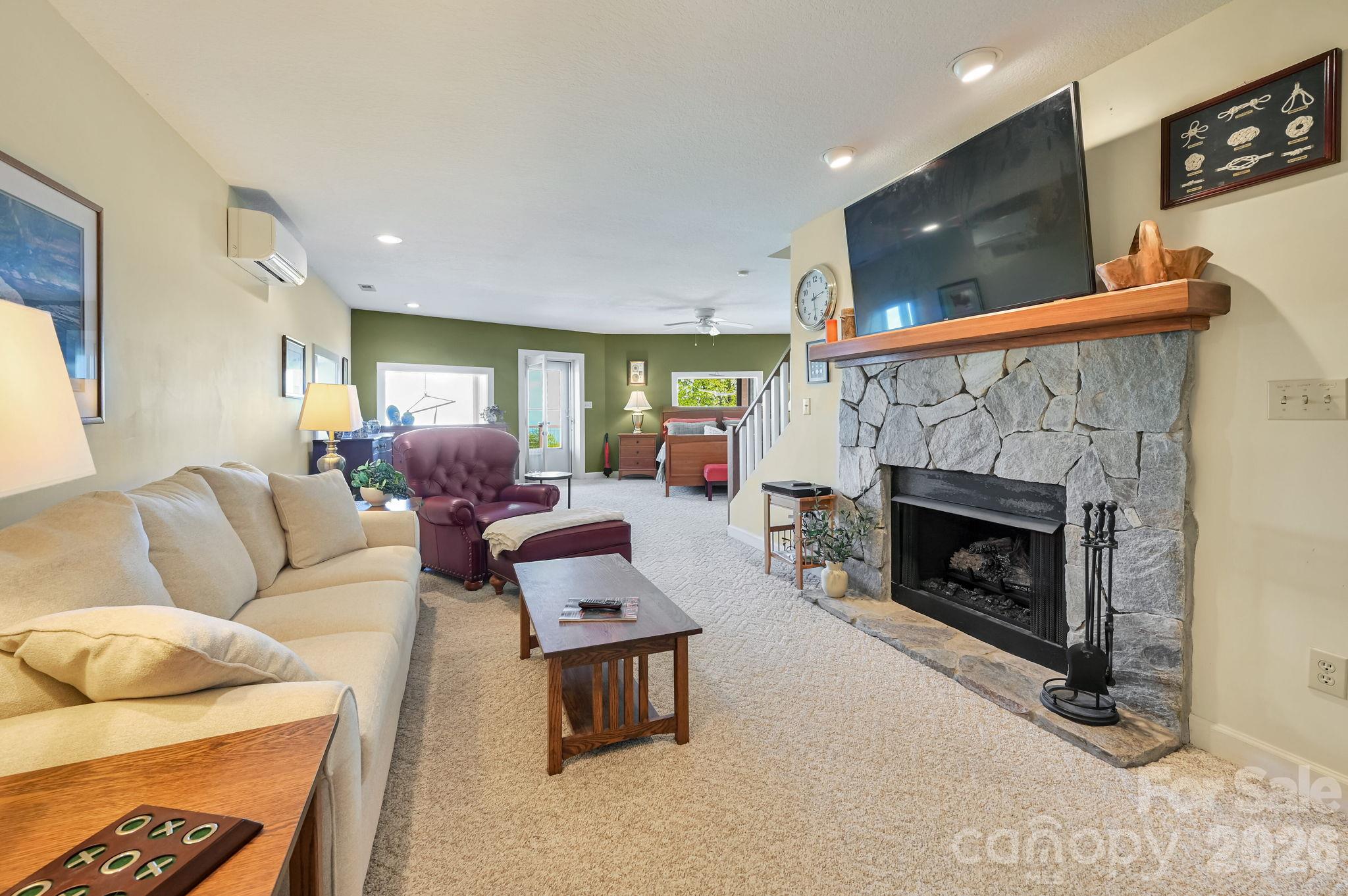 The Lower level Primary features an electric fireplace - 107 Fawns Rest None, Black Mountain