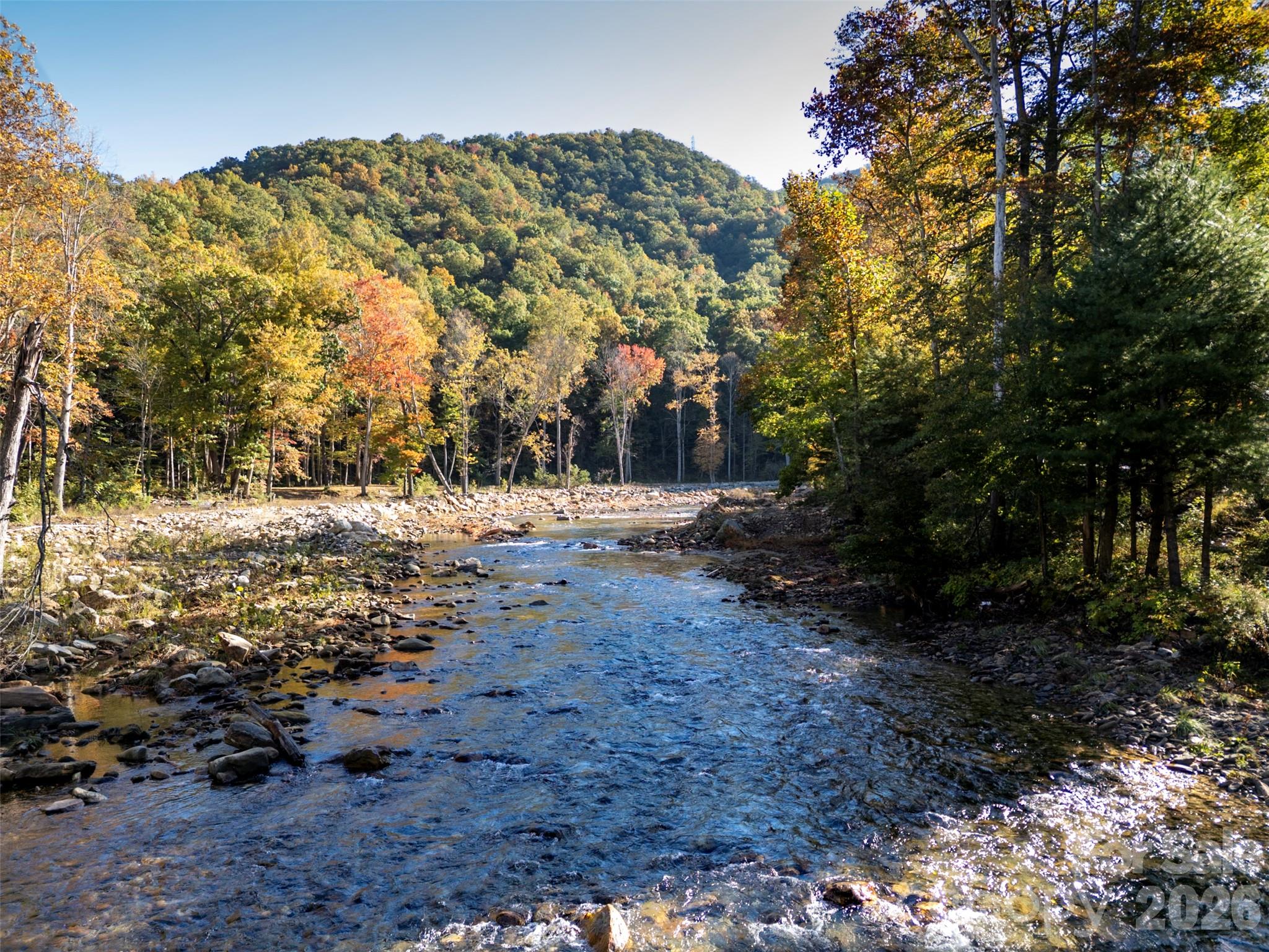 Beautiful mountain scenery and the flowing East Fork of the Pigeon River in autumn. - 13858 Cruso Road, Canton