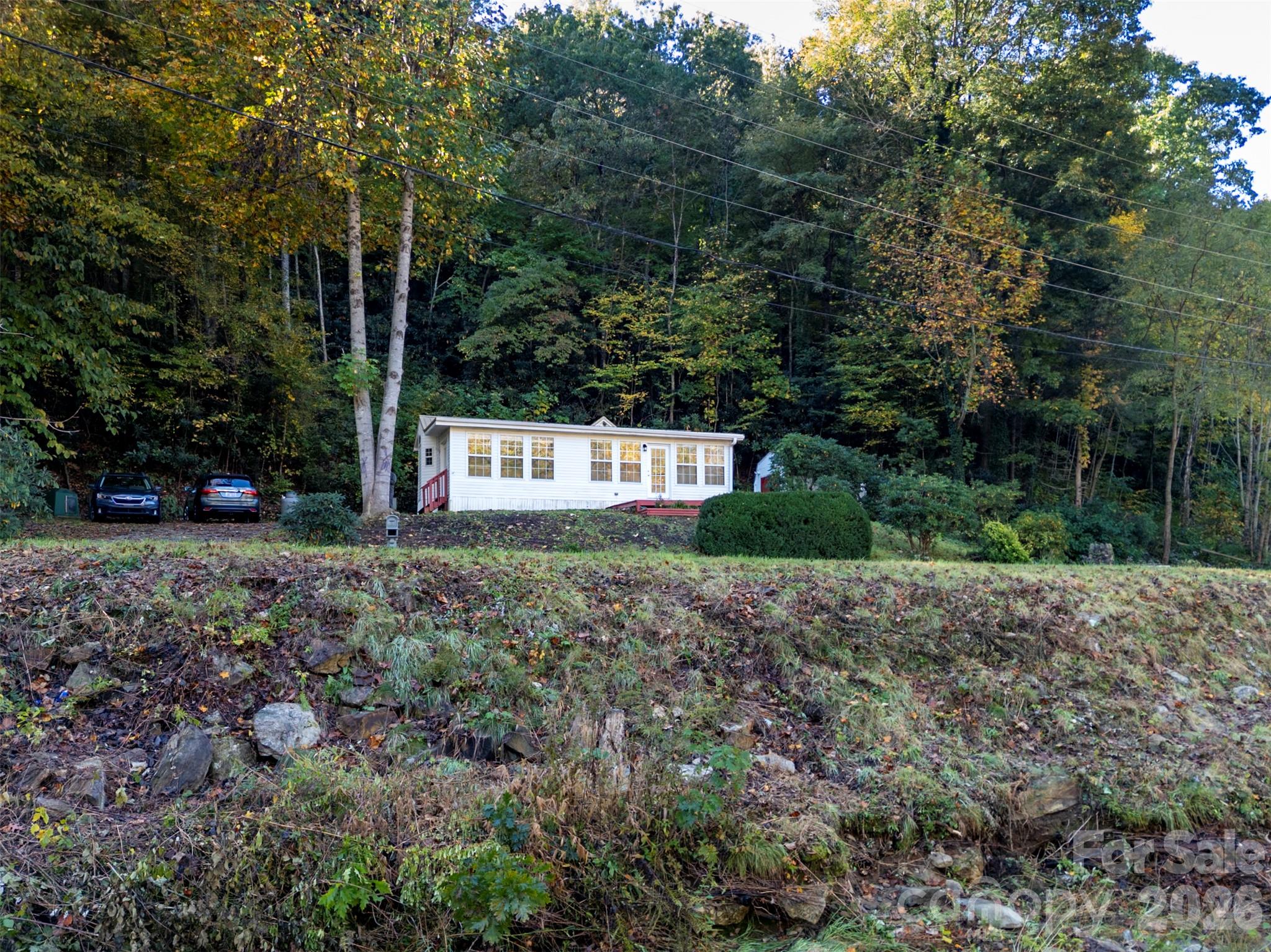 Riverfront setting with the home visible across Cruso Road. - 13858 Cruso Road, Canton