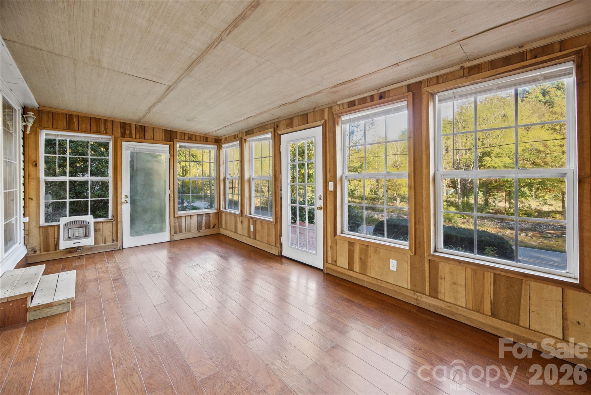 Additional sunroom perspective highlighting the natural wood interior. - 13858 Cruso Road, Canton