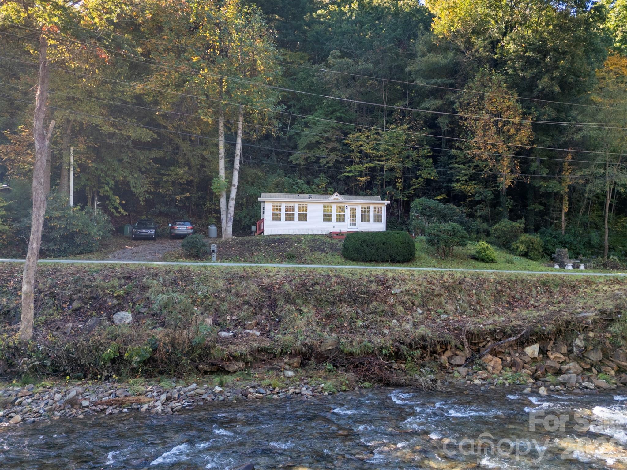 Park Model sits well above the river and per Seller did not receive any flood damage from Hurricane Helene. - 13858 Cruso Road, Canton