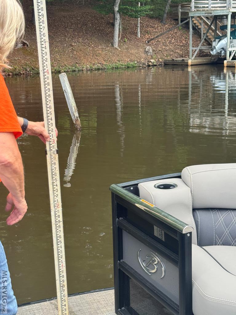 Water level close to boathouse, This measurement of 3'-1" was taken near the post close by the boathouse on 07/08/26. See the boathouse just beyond where we are in the boat. - 796 Tanglewood Drive, Bracey VA 23919