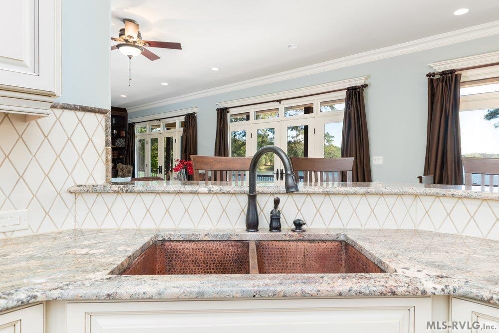 Double-Basin Hammered Copper Sink, Paired with elegant stone countertops and a modern gooseneck faucet and with a view - 381 West Bend Dr., Gasburg VA 23857