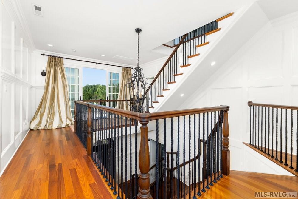 Elegant Upper-Level Hallway and Staircase, This space effortlessly links the private upper-level rooms while maintaining an open view of the floor below. - 381 West Bend Dr., Gasburg VA 23857