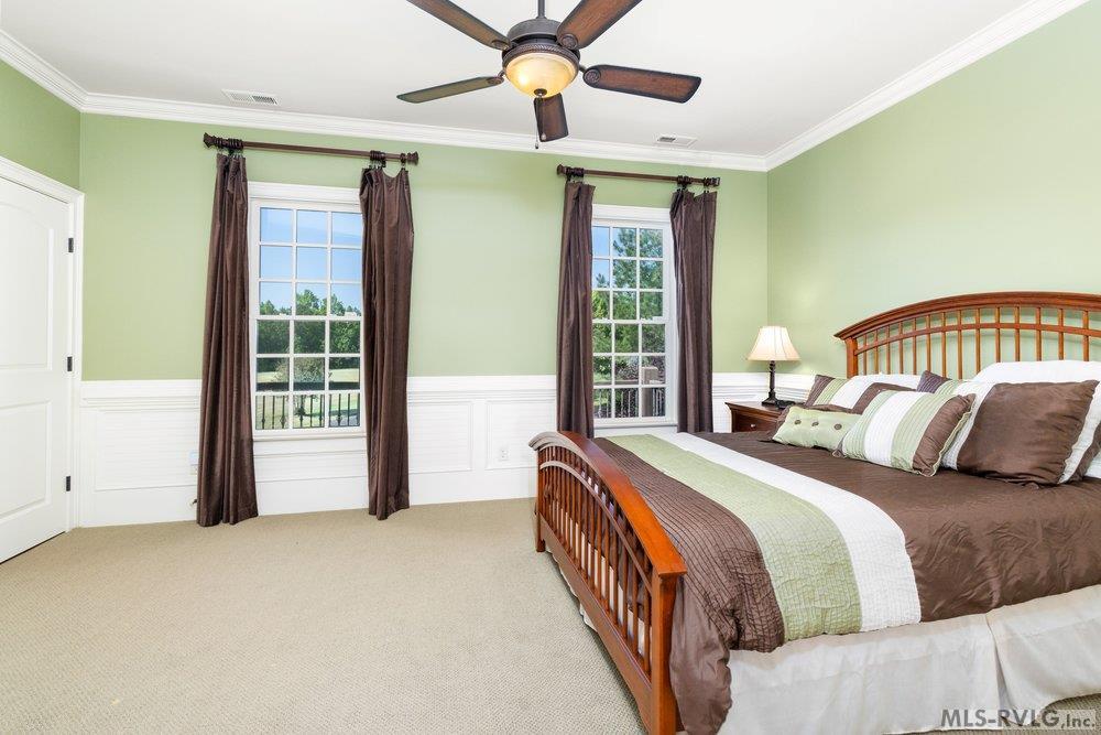Upper Level Road Side Bedroom, A perfect getaway for family and friends, offering a view of the expansive, beautifully manicured lawn. - 381 West Bend Dr., Gasburg VA 23857