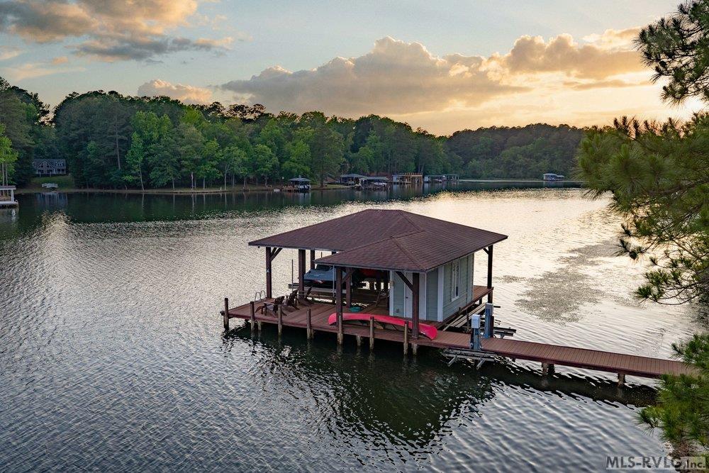 Serene Lake Life, Whether you're launching for a sunrise paddle or watching the sky turn to gold from your boathouse retreat, this is where 'lake time' truly begins. - 381 West Bend Dr., Gasburg VA 23857