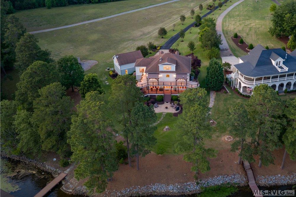 Expanded Lakeside Luxury, This property comes with an extra open lot right next to the main house. Keep it as a huge yard for maximum privacy, or use the space to build. It’s an ideal spot for a guest house, a private pool. - 381 West Bend Dr., Gasburg VA 23857