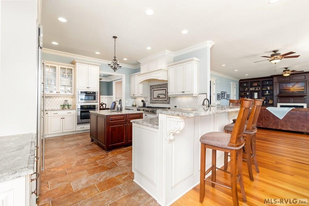Kitchen, The spacious, sunlit kitchen is a chef’s delight, effortlessly combining style and functionality. Its open design flows naturally into a casual breakfast bar seating area, ideal for both entertaining - 381 West Bend Dr., Gasburg VA 23857