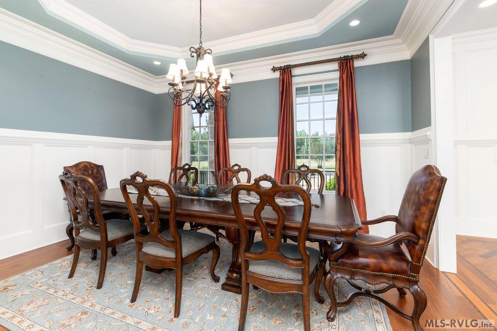 Dining Room, Host unforgettable gatherings in the sophisticated formal dining room, where timeless architecture meets refined style. Classic wainscoting and detailed crown molding create a layered, high-end design - 381 West Bend Dr., Gasburg VA 23857